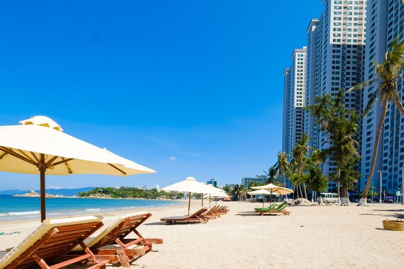 Sun loungers and palm trees on the quiet northern end of Nha Trang beach