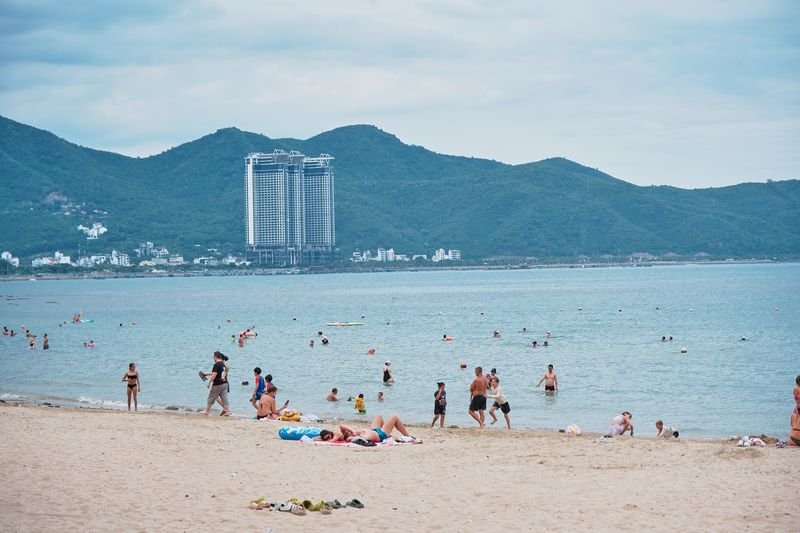 Swimmers enjoying clear water on the beach near Hon Chong