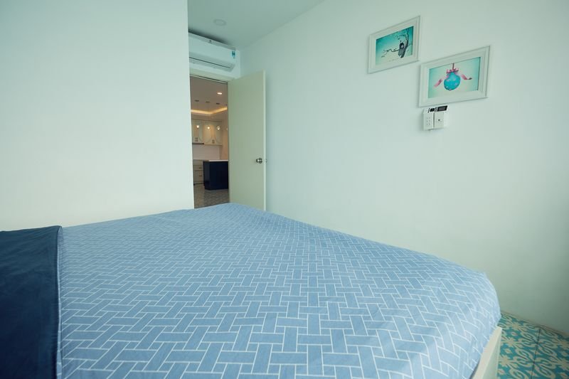 Detail of the king bed with patterned blue linen