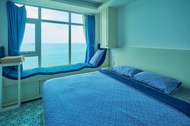 Bedroom with king bed and full-width window over the bay