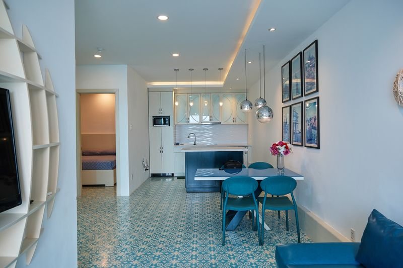 Villa entrance view of kitchen, dining and TV wall
