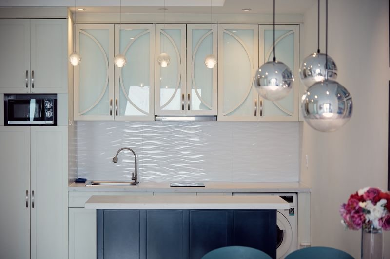 Kitchen island with mirrored pendant lights and flowers