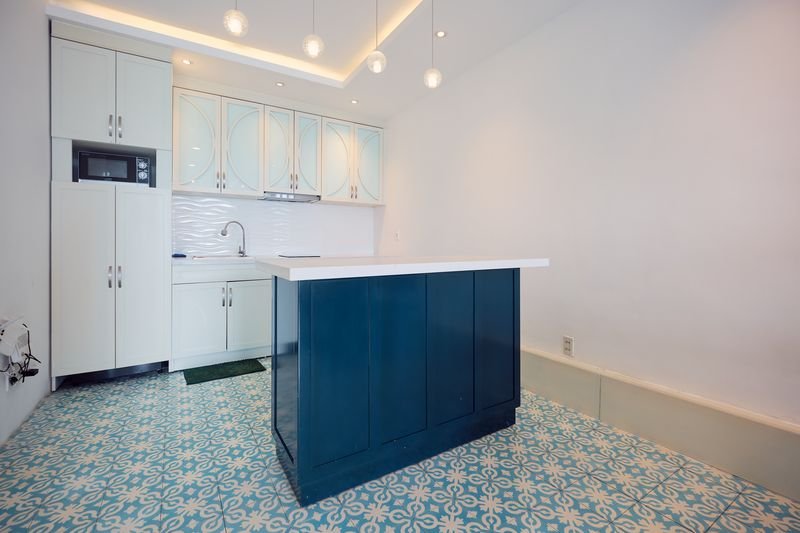 Fully equipped white kitchen with microwave and cooktop