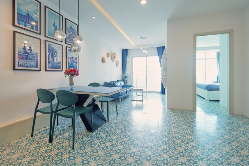 Bright open living and dining space with patterned tile floor