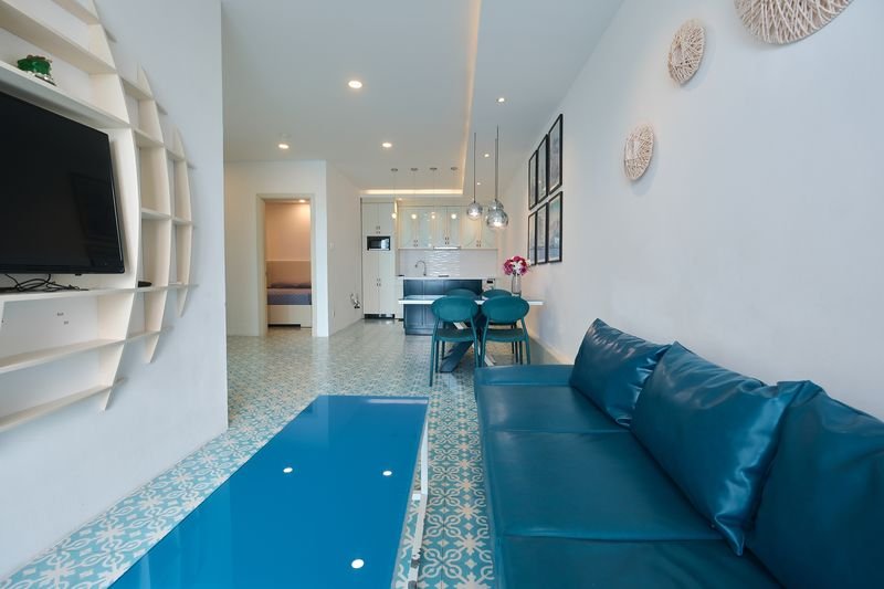 Villa lounge with curved TV shelf and bedroom beyond