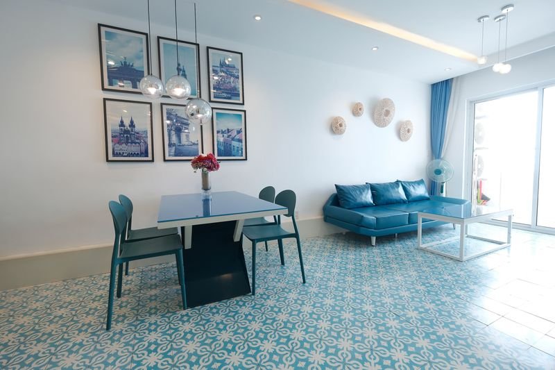Wide villa living space with sofa, dining and kitchen